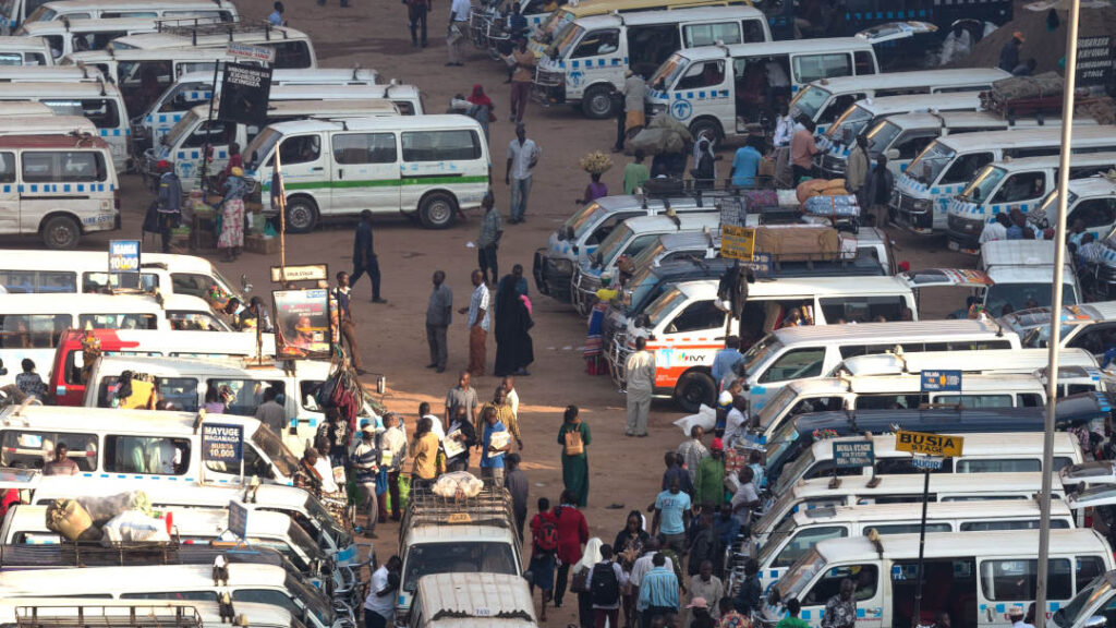 Rows of white minibus taxis in Kampala, Uganda